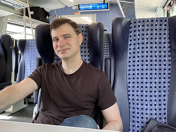 Michael sitting in Business Class on an Amtrak train.