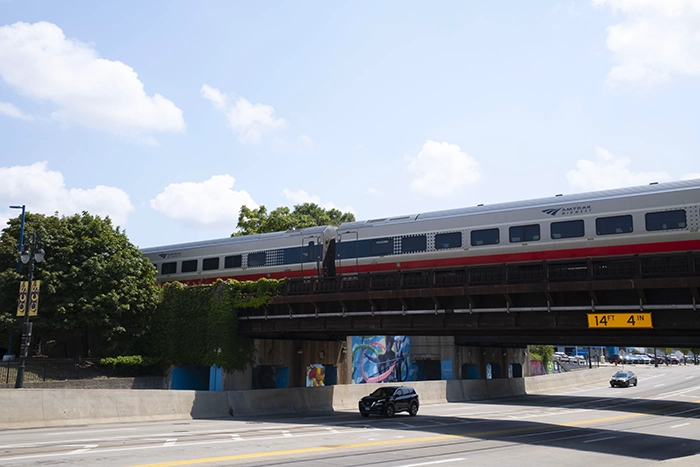 Amtrak Vs Flying. An image of the Amtrak midwest train going over a bridge near the Detroit Amtrak station in Detroit, MI.