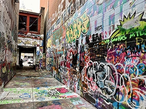 Cover image for 'Graffiti Alley Sucks Now'. Picture of Graffiti Alley in downtown Ann Arbor, MI