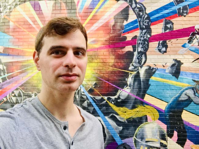 Author Michael DeFranceschi in front of a mural in uptown Charlotte, NC, USA
