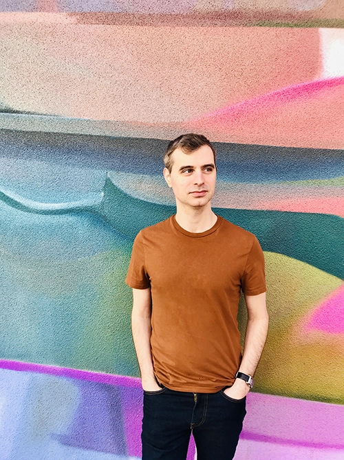 Travel blogger Michael DeFranceschi standing in front of a mural in downtown Phoenix, AZ, USA